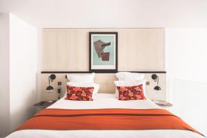 a bedroom with a large bed with two lamps at test etablissement in Sfax