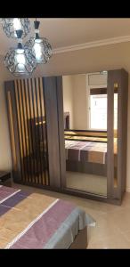 a large mirror in a room with a bed at Appartement 3 meublé équipé in Nador +6 photos