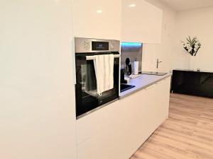 a kitchen with a black and white oven at Enjoy Dresden Appartement in Dresden