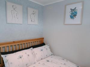 a bedroom with a bed with drawings on the wall at The Chalet in Skegness