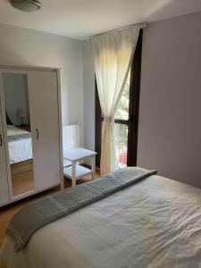 a bedroom with a large bed and a window at Apartamento Villanua centro in Villanúa