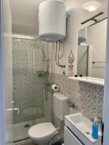 a bathroom with a toilet and a shower and a sink at Maris Rogoznica in Rogoznica +43 photos