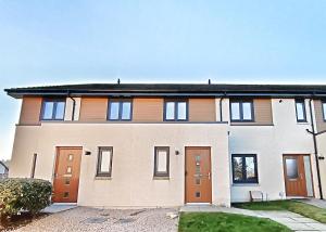 a large house with orange and white at 4 miles to Westhill by Lains Lettings in Aberdeen