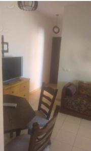 a living room with a table and a couch at Dolce Vita Nid Douillet alias Havre de Paix O Coeur d Ifrane in Ifrane