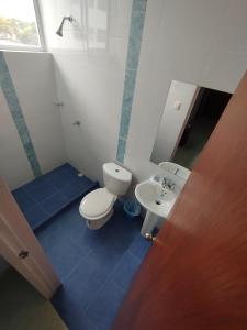 a bathroom with a toilet and a sink at Hotel Camino al Llano in Villavicencio +42 photos