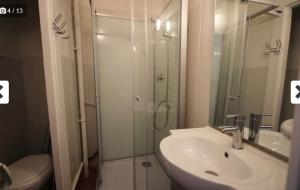 a bathroom with a shower and a sink and a toilet at Studio N2 Rez De Chaussée in Néris-les-Bains