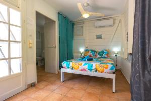 Postel nebo postele na pokoji v ubytování Charmant bungalow avec jardin au Vauclin