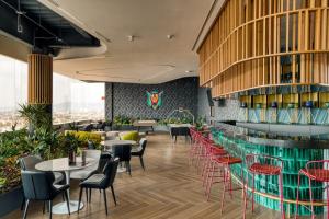 a restaurant with tables and chairs and a bar at Resort Home with Extraordinary City View in Mexico City