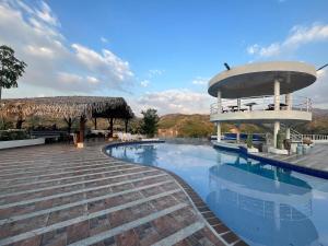 a pool at a resort with a building at Hotel Parque la Casona in La Jagua de Ibirico