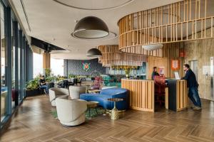 a lobby of a restaurant with people sitting at a counter at Resort Home with Extraordinary City View in Mexico City +75 photos