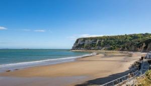 a view of a beach with a cliff at Holiday Home with Private Hot Tub in Bembridge