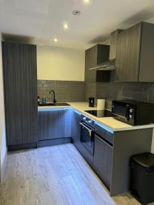 a kitchen with a sink and a counter top at Elegantstays in Bradford