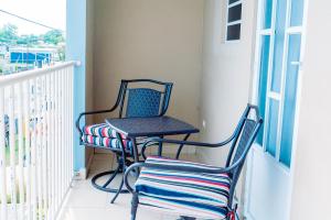 two chairs and a table on a balcony at Charming & Family-Friendly Boqueron Village Condos! in Boqueron