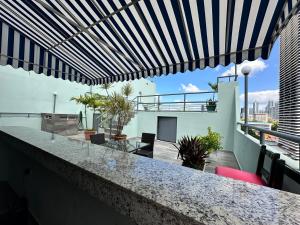 a balcony with a bar on top of a building at HOTEL 2 Mares PANAMA in Panama City