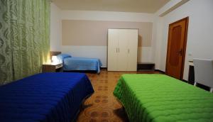 1 dormitorio con 2 camas con sábanas azules y verdes en Casa Grande, en Matera