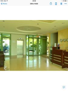 a room with glass doors and a lobby with a desk at Lozenetz Beach Apartments in Lozenets +239 photos