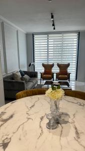a living room with a table with a vase of flowers on it at 2 bedroom luxury Ellipse waterfall in Midrand