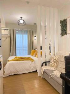 une chambre avec un lit et un canapé dans l'établissement The Zen Den, Pine Suites Tagaytay, à Tagaytay