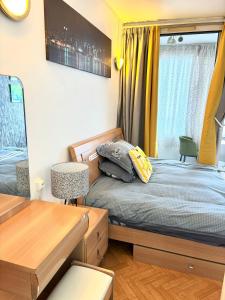 a small bedroom with a bed and a window at Chambre Lucas Salle de bain Privative in Paris