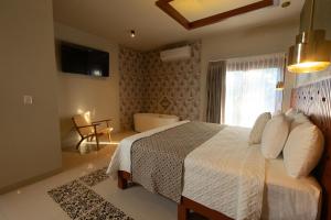 Postel nebo postele na pokoji v ubytování Hotel Poquito a Poquito