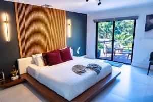 a bedroom with a large white bed with red pillows at Luhos Paradise - Pickleball Extravaganza L07 in Miami +74 photos