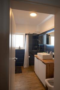 a bathroom with a sink and a toilet at Misty Central Residence in Baia Mare +26 photos