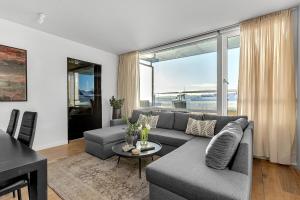 a living room with a couch and a table at Spacious 3BR Location free park in Reykjavík