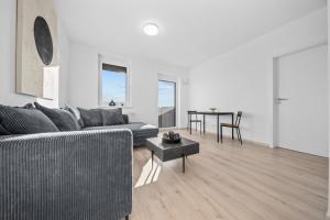 a living room with a couch and a table at Modern 2-Bedroom Apartment in the Heart of Bratislava in Bratislava