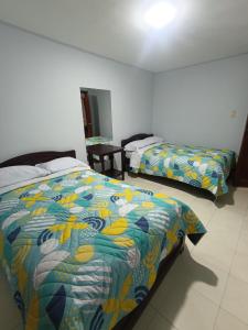 Hotel Gamma Pasto客房内的一张或多张床位