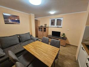 a living room with a couch and a table at House Sunshine in Mrljane