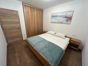 a bedroom with a bed and a painting on the wall at House Sunshine in Mrljane