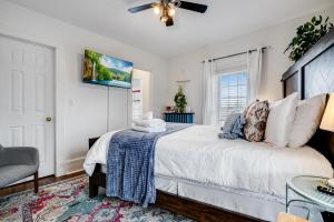 a bedroom with a bed and a ceiling fan at The Miracle Room at Dream BNB Estate Inn in Leamington