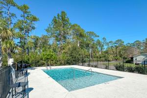 a swimming pool in a yard with a fence at Endless Summer in Orange Beach