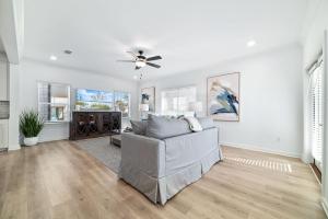 a living room with a couch and a ceiling fan at Endless Summer in Orange Beach +39 photos