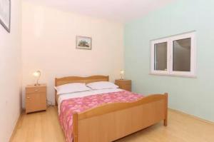 a bedroom with a bed and a window at Villa Casa with indoor pool in Krilo