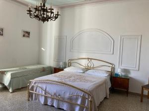 a bedroom with a bed and a chandelier at Affittacamere Ponte di Marmo in Livorno