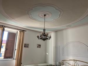 a chandelier hanging from a ceiling in a room at Affittacamere Ponte di Marmo in Livorno