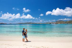 a man and a woman standing on a beach at Secret Harbour Beach Resort in Nazareth +193 photos