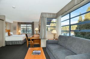 a hotel room with a bed and a couch at Listel Whistler, a Coast Hotel in Whistler