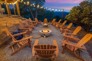 a group of chairs sitting around a fire pit at Yosemite Lookout Lodge w/ hot tub, firepits, game room, and more in Oakhurst