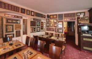 a restaurant with wooden tables and chairs and a television at Pension Masonic House in Loket