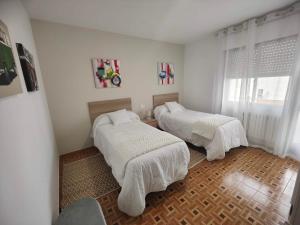Ένα ή περισσότερα κρεβάτια σε δωμάτιο στο Casa Marga O Grove