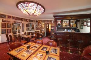 a restaurant with tables and chairs and a chandelier at Pension Masonic House in Loket