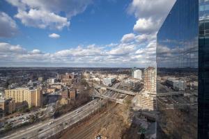 a view of a city with a tall glass building at Chic Apt with Indoor Pool & Gym-333-2509 in New Rochelle