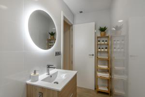 a bathroom with a sink and a mirror at Laguna Home in Ayamonte +45 photos