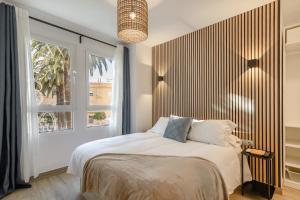 a bedroom with a large bed and a window at Laguna Home in Ayamonte