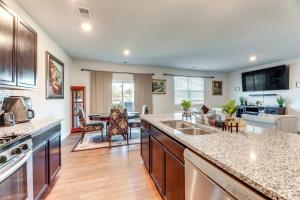 a kitchen with a counter top and a living room at 17 Mi to Dtwn Nashville Family-Friendly Gem in Antioch
