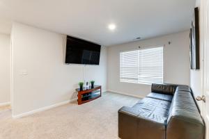 a living room with a leather couch and a flat screen tv at 17 Mi to Dtwn Nashville Family-Friendly Gem in Antioch