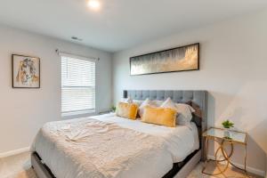a bedroom with a large bed with yellow pillows at 17 Mi to Dtwn Nashville Family-Friendly Gem in Antioch