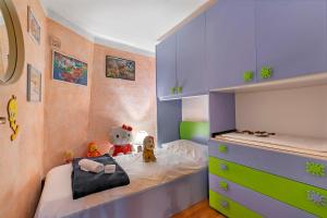 a childs bedroom with purple and green cabinets at La Lanterna Swimming Pool Retreat - Happy Rentals in Gignese